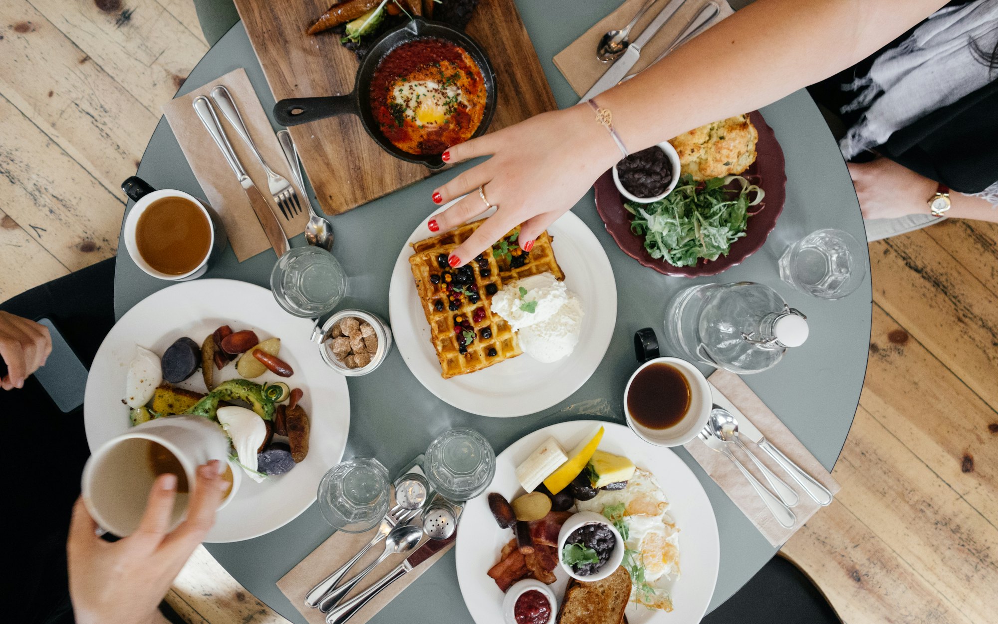 Friends sharing plates around a dining table