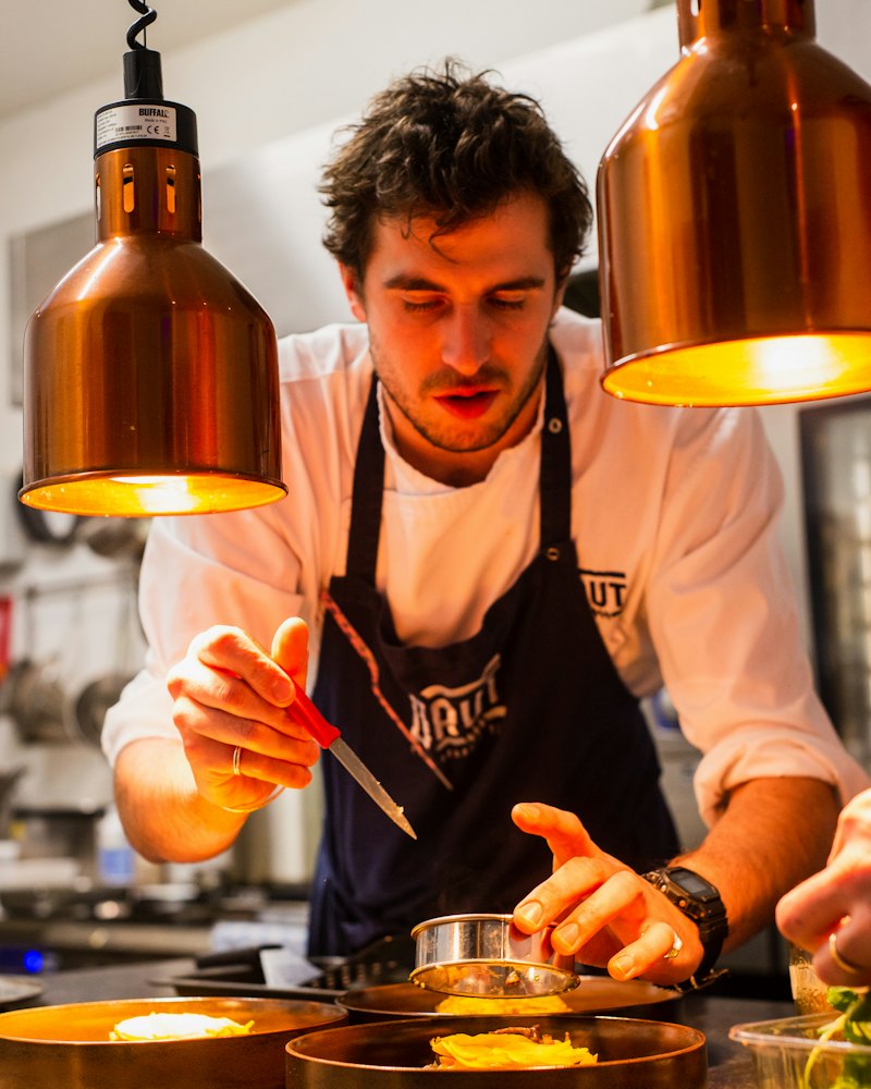Chef carefully finishing a dish