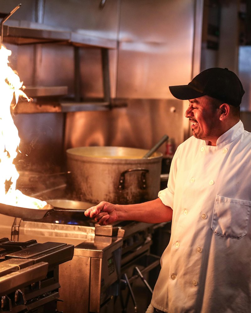 Chef cooking over an open flame