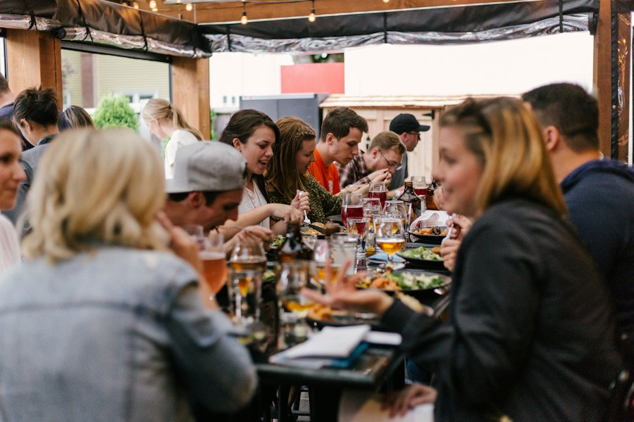 Friends and family laughing over dinner